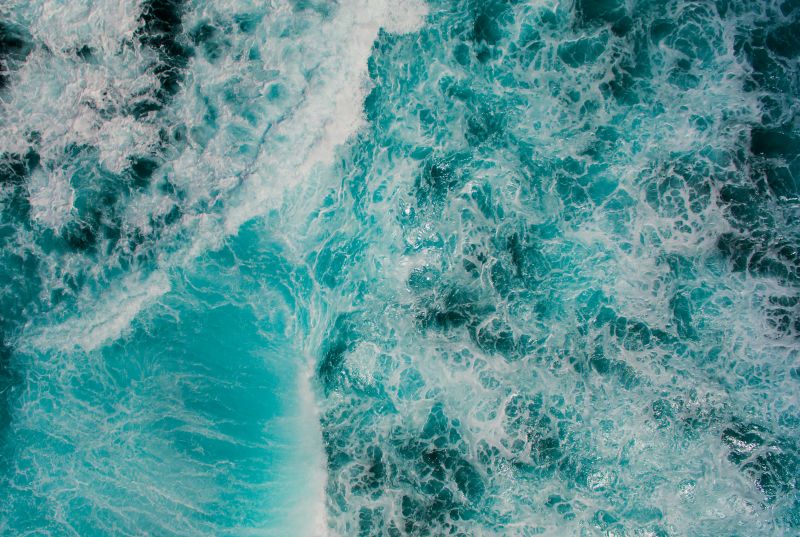 a drone shot of crashing waves
